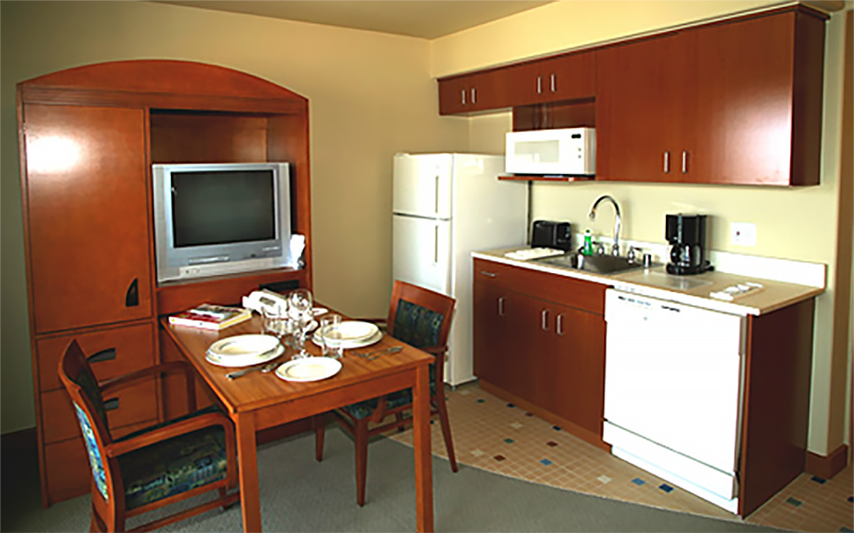 The kitchen and dining area of a First Cabin Club suite