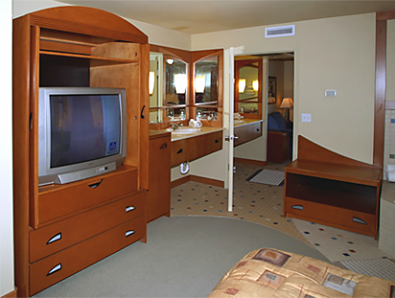 A view of the television in the armoire of the bedroom and the bathroom of a First Cabin Club suite